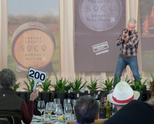 Sonoma County Barrel Auction auctioneer John Curley on stage
